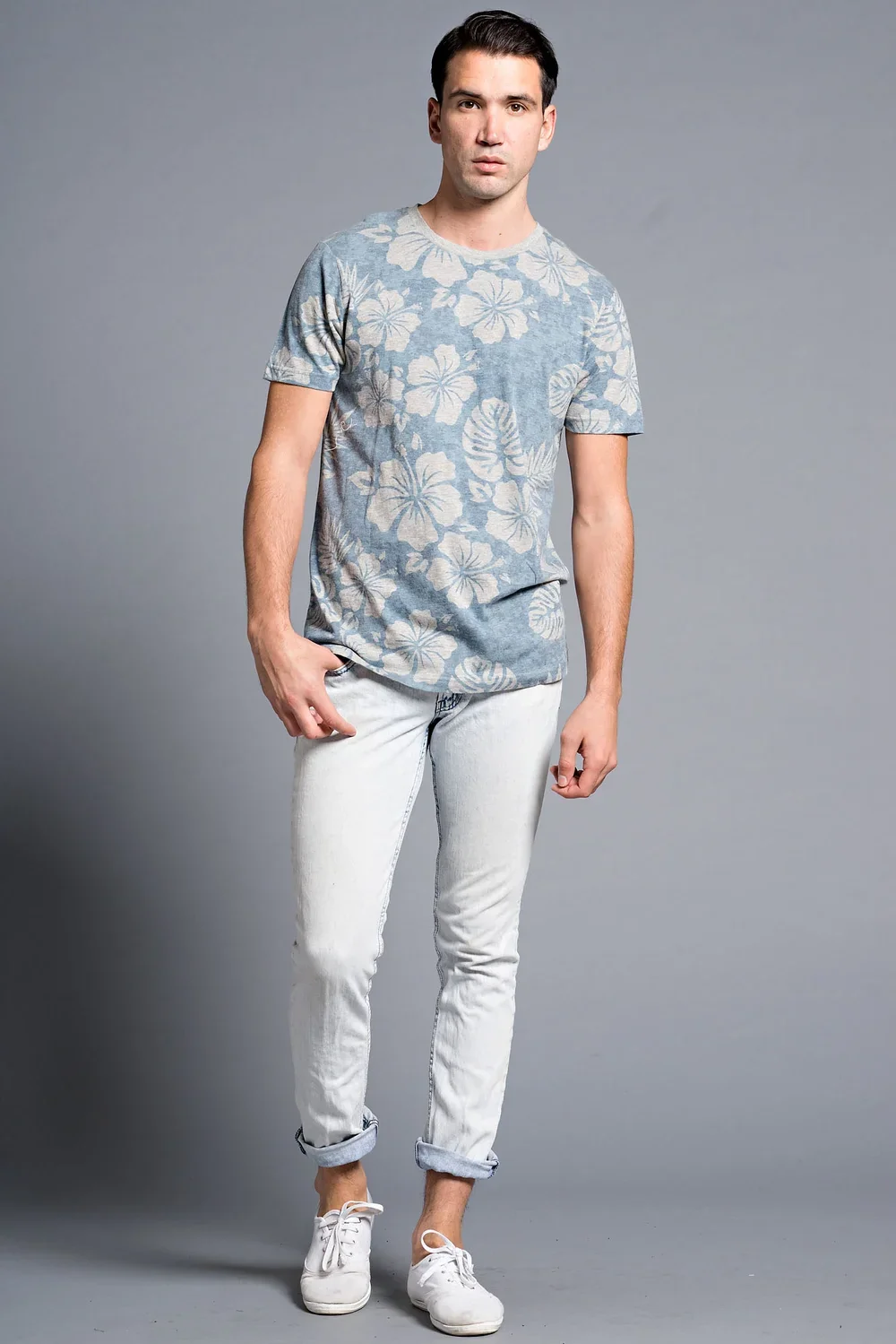 Man wearing a light blue floral t-shirt and white jeans — Urban Nation men's casual wear